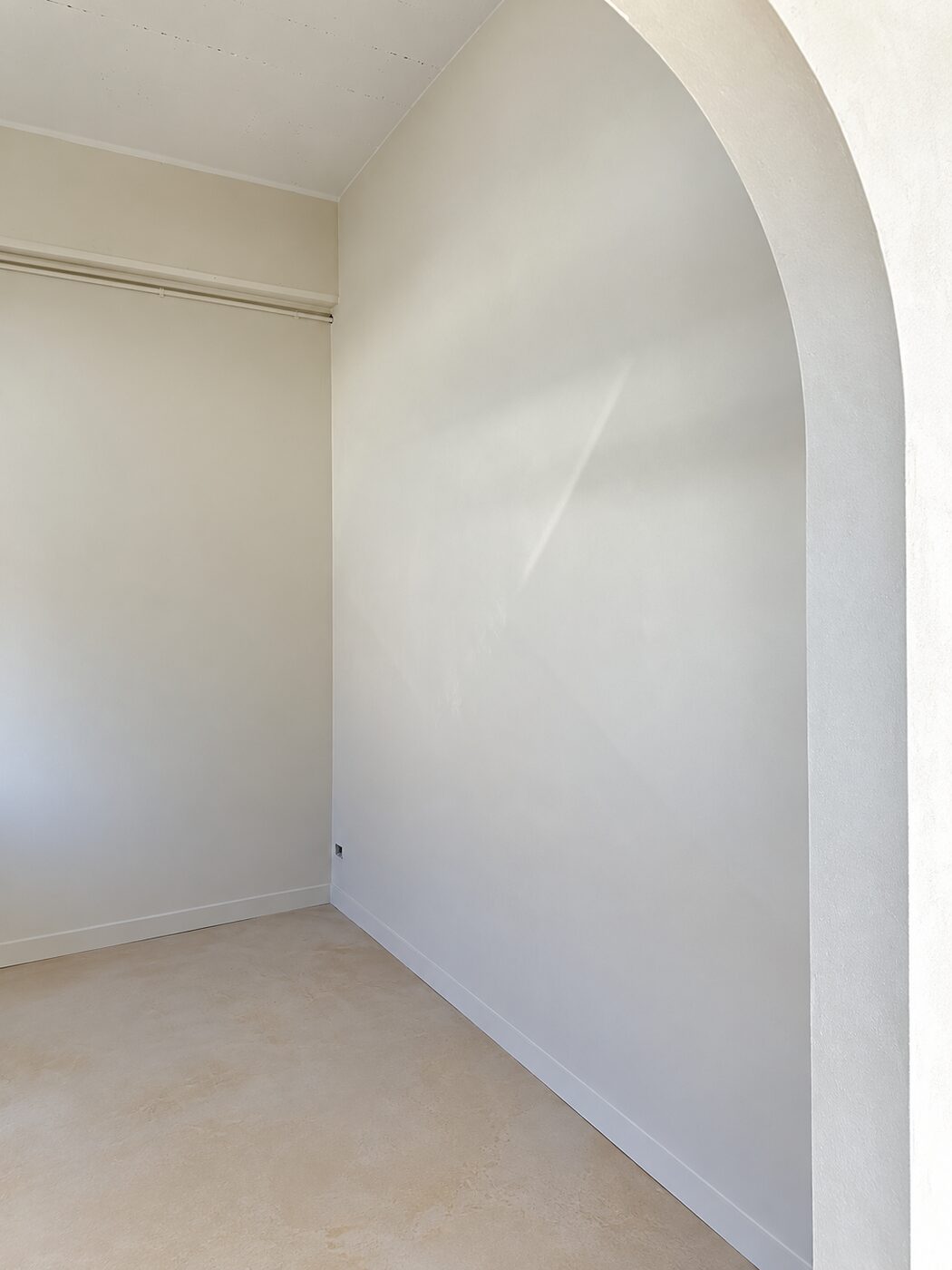 Smooth plastered arch and wall catching the afternoon light